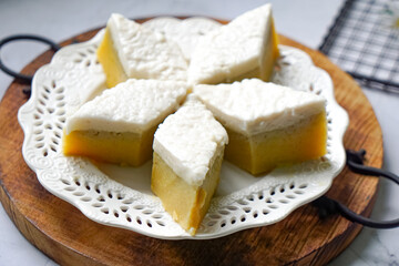 Kuih Talam Pisang, a steamed dessert made with banana and rice flour, featuring a soft, layered texture and sweet, creamy flavor.