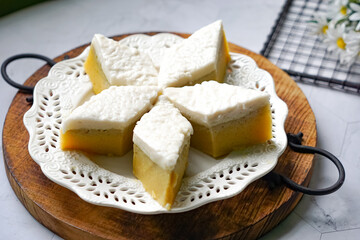 Kuih Talam Pisang, a steamed dessert made with banana and rice flour, featuring a soft, layered texture and sweet, creamy flavor.