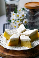 Kuih Talam Pisang, a steamed dessert made with banana and rice flour, featuring a soft, layered texture and sweet, creamy flavor.