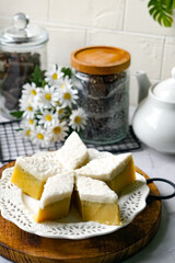 Kuih Talam Pisang, a steamed dessert made with banana and rice flour, featuring a soft, layered texture and sweet, creamy flavor.