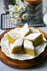 Kuih Talam Pisang, a steamed dessert made with banana and rice flour, featuring a soft, layered texture and sweet, creamy flavor.