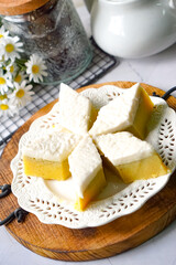 Kuih Talam Pisang, a steamed dessert made with banana and rice flour, featuring a soft, layered texture and sweet, creamy flavor.