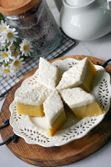 Kuih Talam Pisang, a steamed dessert made with banana and rice flour, featuring a soft, layered texture and sweet, creamy flavor.