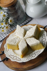 Kuih Talam Pisang, a steamed dessert made with banana and rice flour, featuring a soft, layered texture and sweet, creamy flavor.