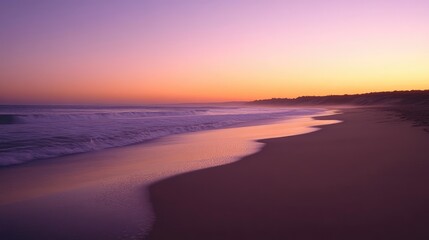 A deserted sandy beach at sunset, where gentle waves wash ashore as the sky transitions from orange to purple, meeting the horizon.