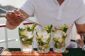 Refreshing Mojito Cocktails with Fresh Mint and Lime on a Sunny Deck