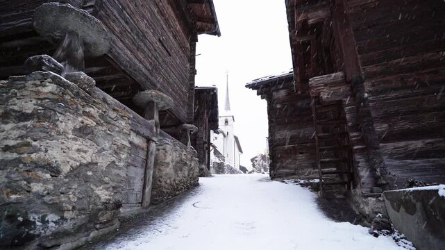 Snow Falling At Alpine Houses During Winter In Blatten bei Naters Village In Valais, Switzerland.- Relaxing Snowstorm - static shot