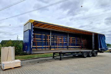 customs control of a van or truck. the car's tarpaulins are raised and suspicious cargo boxes are visible on the pallet. Search for refugees in the body of the truck.