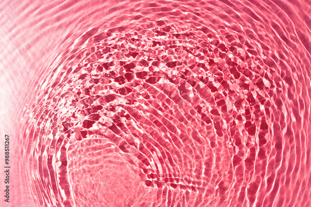 Poster ripples of light and color in a pink water surface reflecting mesmerizing patterns at midday