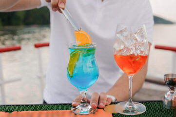 Refreshing Summer Cocktails on a Scenic Outdoor Bar with Vibrant Colors and Citrus Garnish