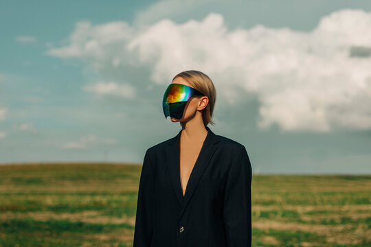 Woman wearing black colored blazer and glass face mask under cloudy sky