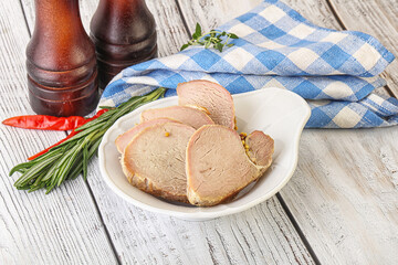 Baked pork tenderloin served rosemary