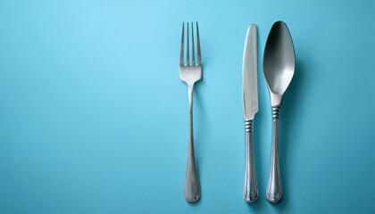 Fork and Knife on a Pastel Blue Background