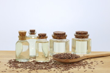  flaxseeds and flaxseed oil on wooden board
