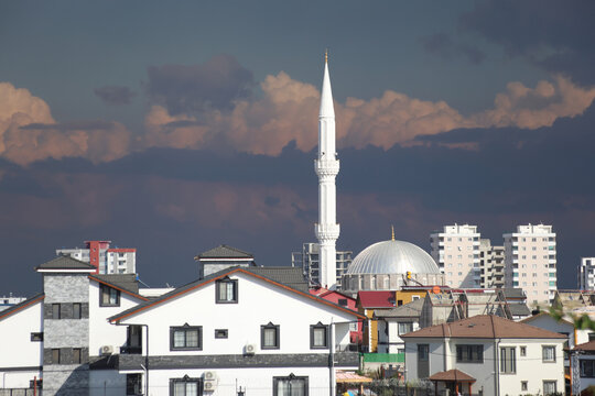  a mosque and minarette surrounded by villas and apartments
