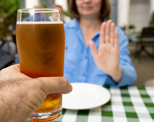 Reject a glass of beer, woman refusing alcohol, stop drinking, sobriety concept, saying no to beer...