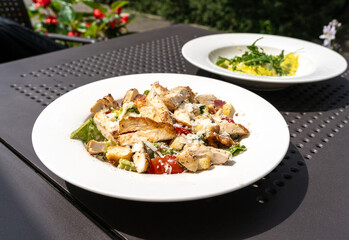 Caesar Salad, Green Lettuce Salat with Chicken and Parmesan Cheese Closeup