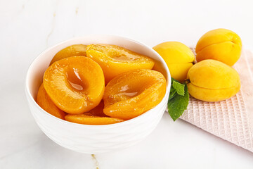 Few canned aprocots in the bowl