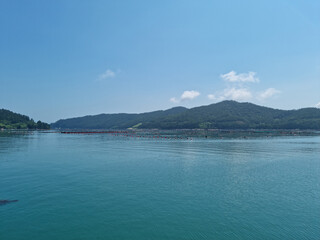 It is a landscape with an island and the sea.