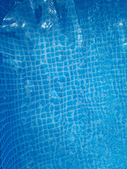 Close-up of swimming pool water with blue tiles