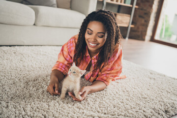 Photo of cute adorable girl dressed orange shirt smiling enjoying her little friend lying foor...