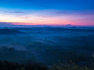 Fototapeta premium Landscape of beautiful morning fog sunrise at Khao Na Nai Luang Dharma Park in Surat Thani province, Thailand