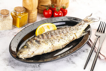 Grilled sea bass fish served lemon