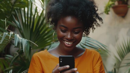 Video Email. African American Girl Smiling as She Types Message on Mobile Phone