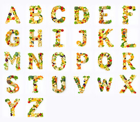Complete alphabet made from fresh fruits and vegetables on white background