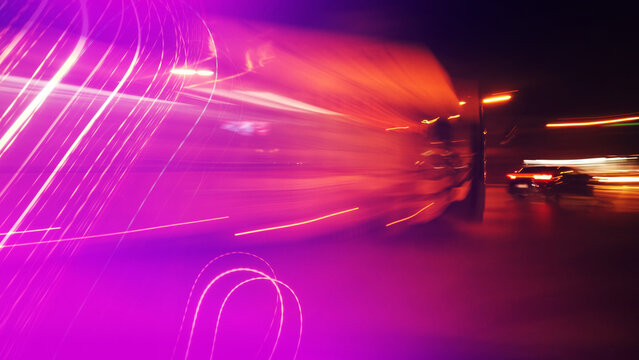 City traffic at night, long exposure image of lights and colors in motion as abstract background