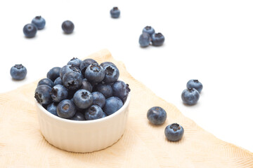 Ripe blueberries in a bowl close-up on a white. Blueberry picking