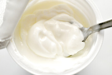 Greek yogurt pot on spoon. Healthy and dietary food.