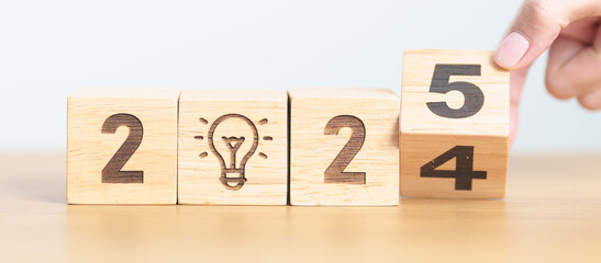2024 year change to 2025 year block with lightbulb. Business Idea, Creative, Thinking, brainstorm,...