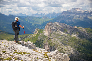 Hiker enjoys the view from Lagazuoi mountain over the italian Dolomites.