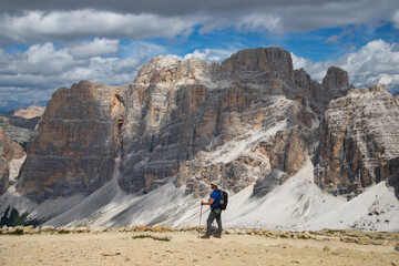 Fototapeta premium Hiker enjoys the view from Lagazuoi mountain over the italian Dolomites.
