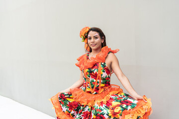 Woman posing in colorful carnival dress with floral patterns and ruffles