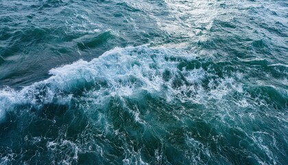 Fototapeta premium Vast Ocean Waves in Motion. Turbulent Aqua Blue Waters with White Foam Crests, Capturing the Natural Energy of the Sea in a Dynamic, Overhead Perspective