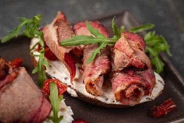 Closeup on portion of bruschetta appetizer with pastrami