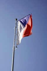 Czech national flag on flagpole in wind