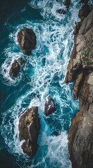 Aerial View of Ocean Waves Crashing Against Rocks