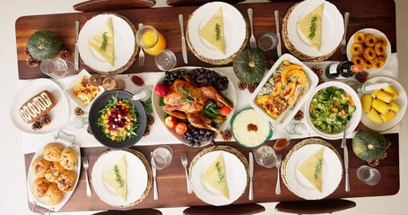 Above, home and food for thanksgiving dinner, celebration and reunion with meal. Wine bottle, glasses and chicken on dining table for love, support and unity with vegetables for gathering or event