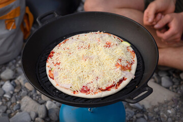 Pizza Prepared in a Wok. Campfire Pizza: Cooking Outdoors in Nature.