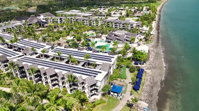 Aerial view of luxury resort hotel with pool, palm trees at Denarau Island beachside. Exotic destination, Fiji.