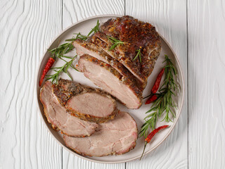Roast Pork Neck sliced on a plate, top view