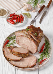 Roast Pork Neck sliced on a plate, top view