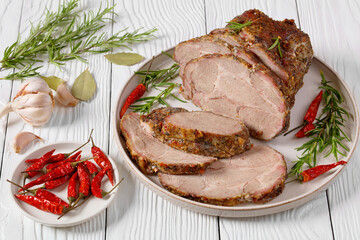 Roast Pork Neck sliced on a plate, top view