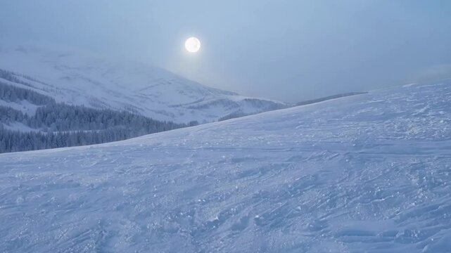 Serene winter night at a ski resort. Illuminated by a bright full moon. Casting a soft glow over the snowy landscape. The empty slopes create a peaceful. Tranquil atmosphere in the cold. Frosty air