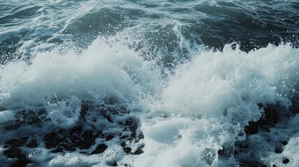 The ocean waves are crashing, creating foamy white crests. The water is turbulent, not calm.