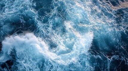 Obraz premium The ocean waves are crashing, creating foamy white crests. The water is turbulent, not calm.