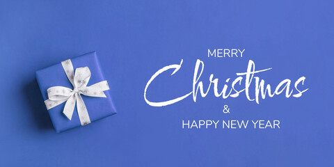 Gift boxe with white bow on a blue backdrop.